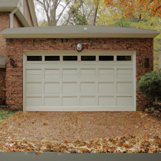 Suburban Tenafly home with a modern closed garage door, driveway and fall leaves in soft morning light.
