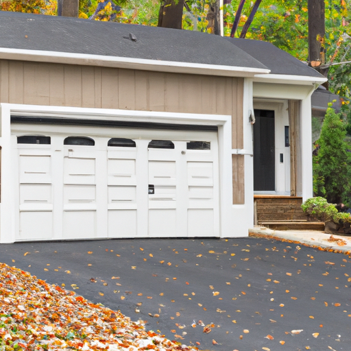 Residential garage door on a Tenafly, NJ street, modern door partially open with tracks visible and autumn foliage nearby.