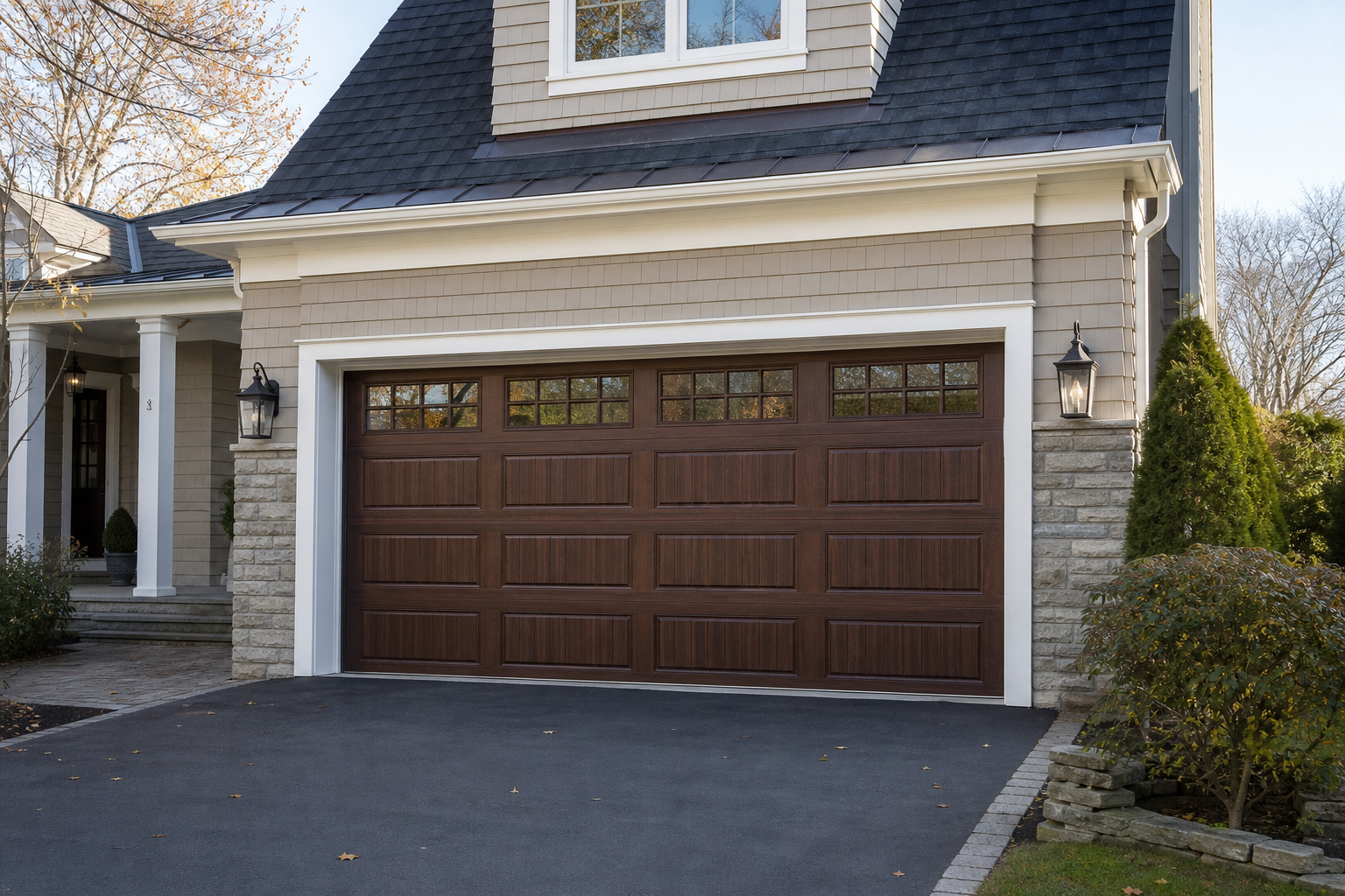 Residential garage door exterior in Tenafly, NJ with a clean driveway and natural daylight